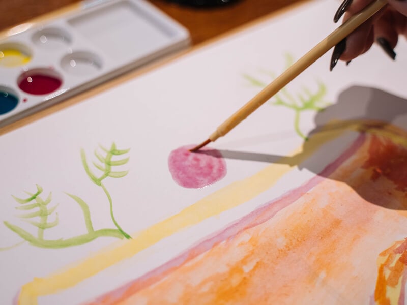Half finished canvas with paint and brush